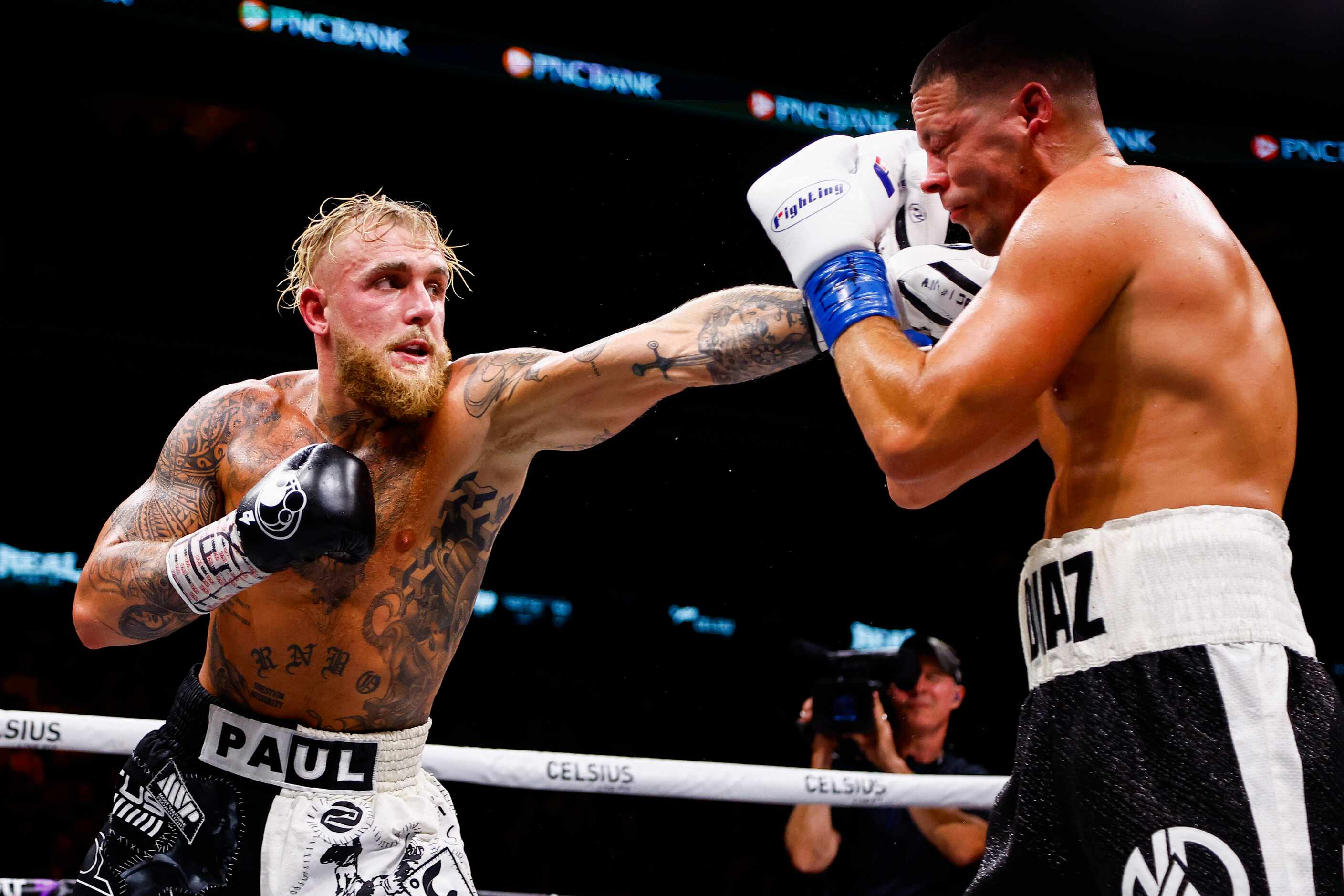 Jake Paul, left, lands a punch on Nate Diaz during a boxing match in Dallas, Saturday,...