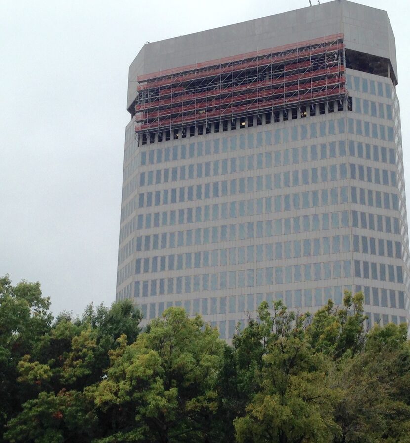 Work crews are still removing the exterior on the upper floors of the 400 Record building...