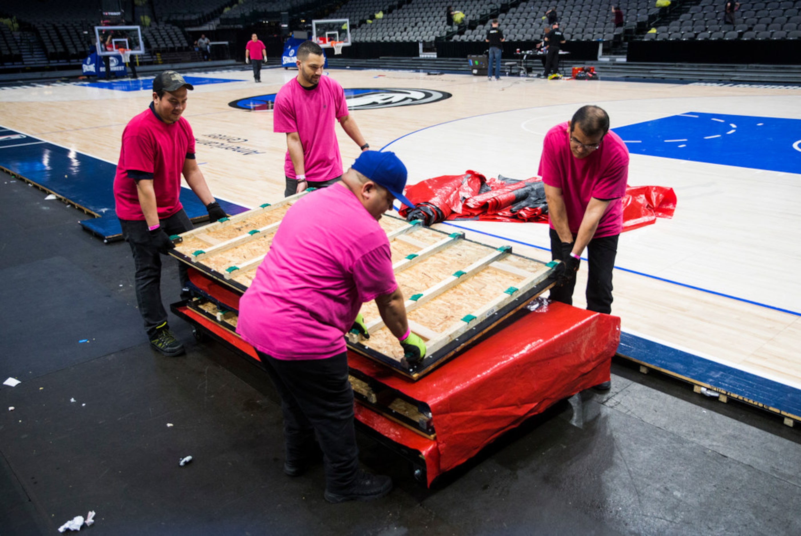 Crews break down the court after the Dallas Mavericks beat the Denver Nuggets 113-97 on...