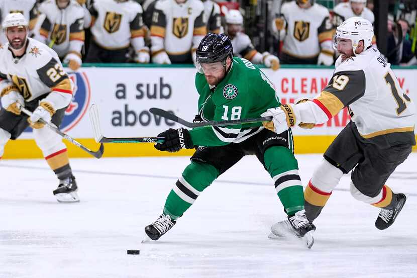 Dallas Stars center Max Domi (18) attempts to take control of the puck as Vegas Golden...