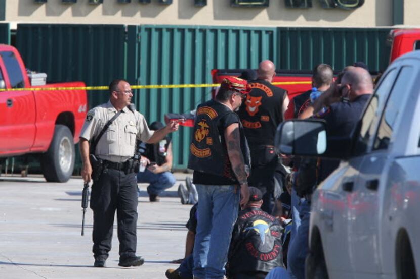 
In this May 17 file photo, authorities investigate a shooting in the parking lot of the...