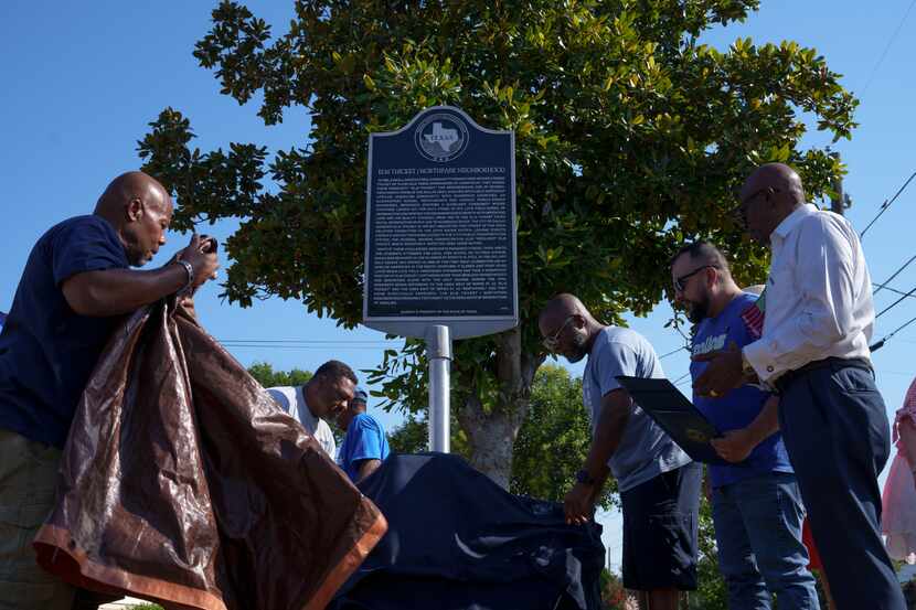 Attendees watch as the new historical marker is unveiled during a Juneteenth celebration in...