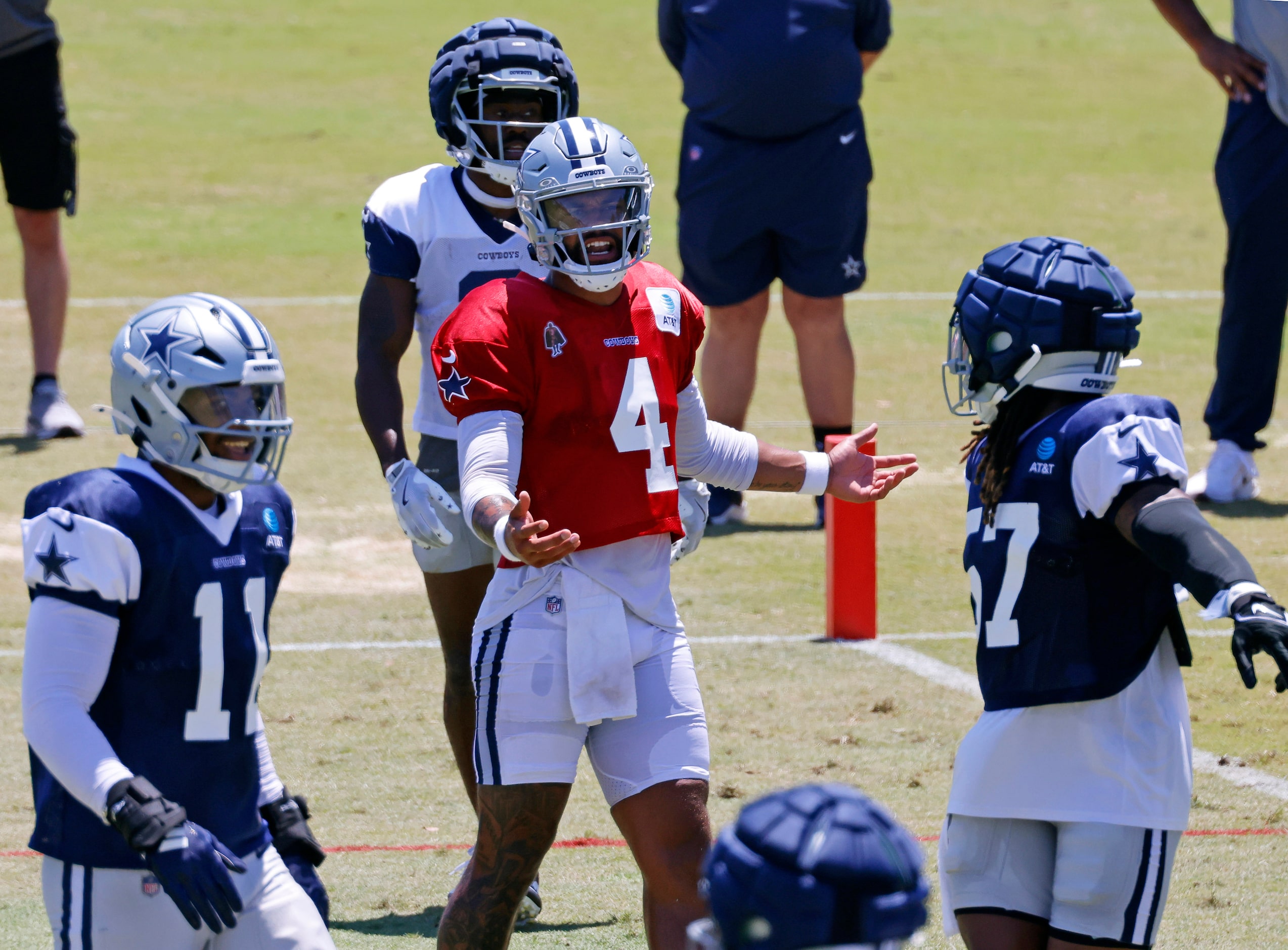 Dallas Cowboys quarterback Dak Prescott (4) is razed by the defense following a play during...