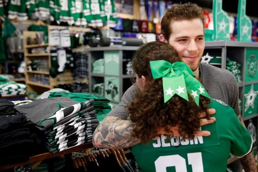 Nicole Berinshteyn, 13, of Plano, Texas, hugs Dallas Stars center Tyler Seguin while Seguin...