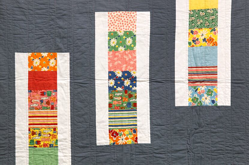 Michelle Kitto of Urban Spools sewing lounge displays some of the modern quilts she and her...
