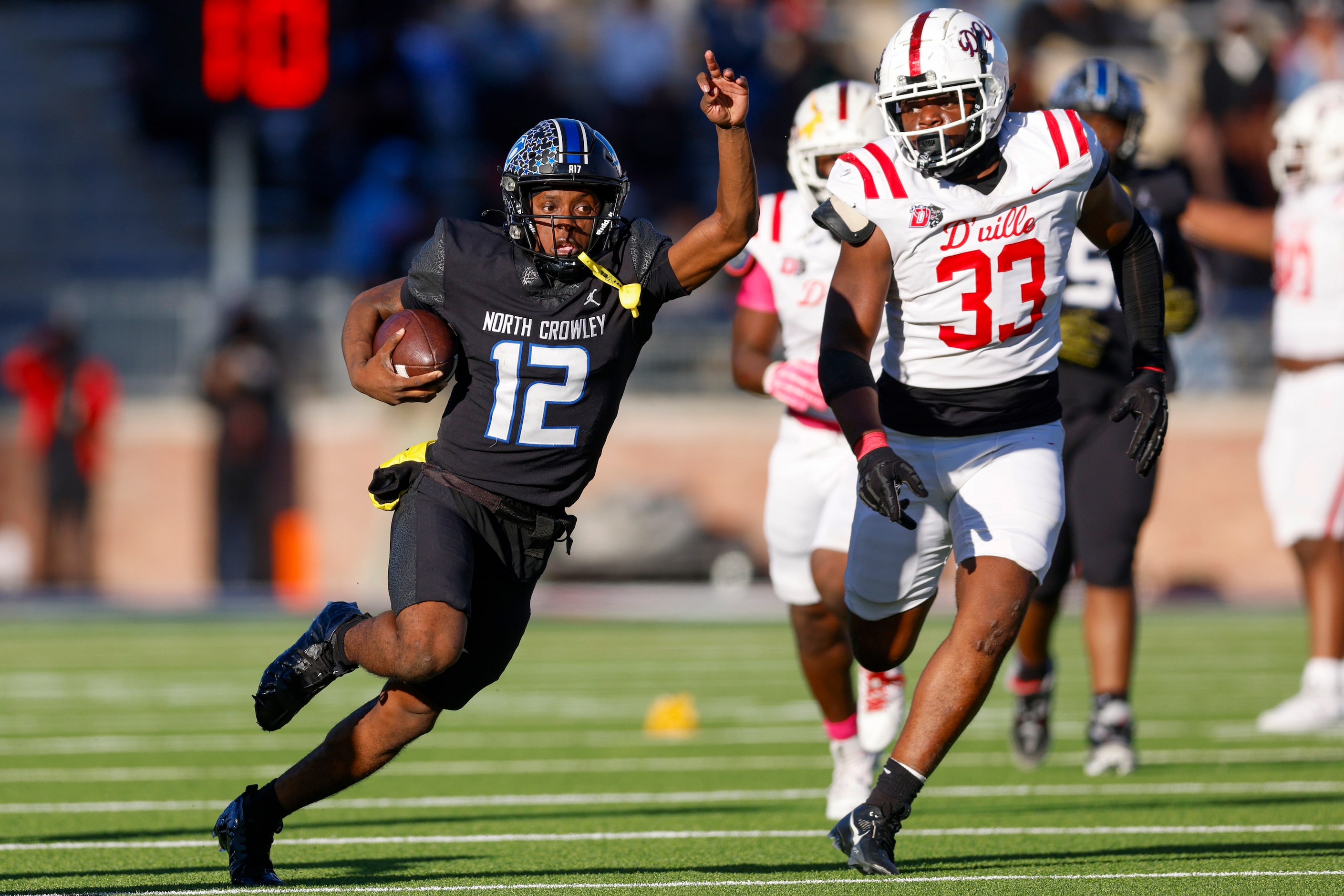 North Crowley quarterback Chris Jimerson Jr. (12) keeps the ball as he runs up field ahead...