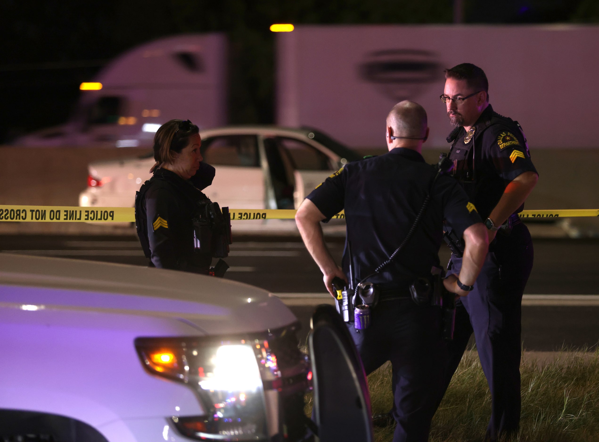 Officers stand watch over a crime scene on Interstate 35 in Lewisville, TX, on Aug 30, 2024.