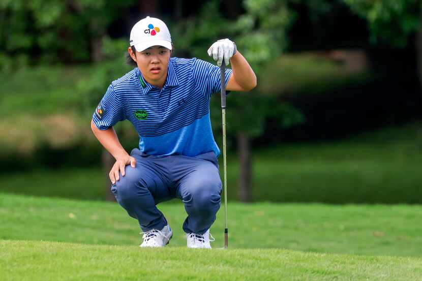 Amateur Kris Kim, 16, lines up his shot near the 12th green during the first round of The CJ...