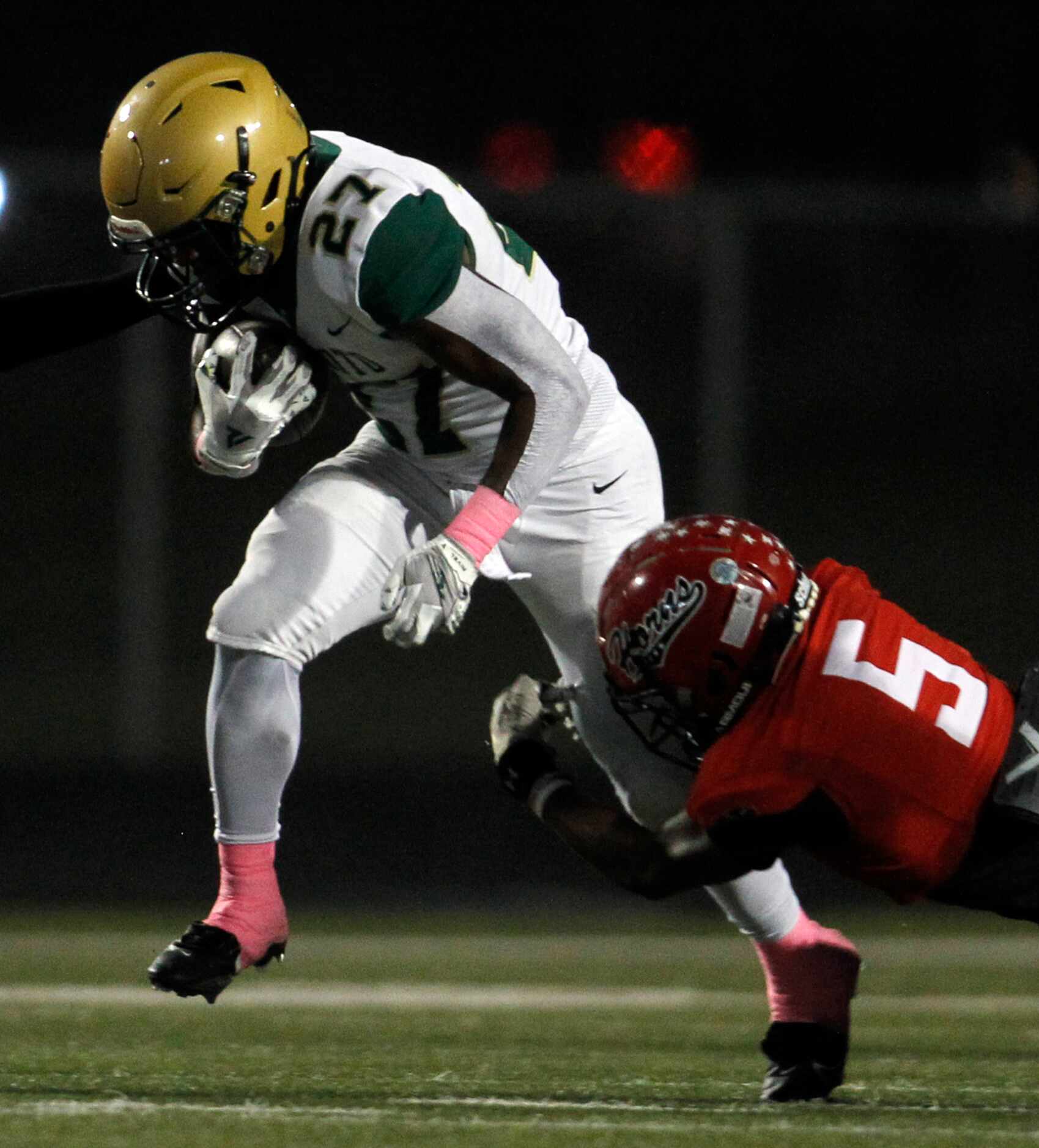 DeSoto running back Marvin Duffy (27) rushes for a first down before being tackled by Cedar...