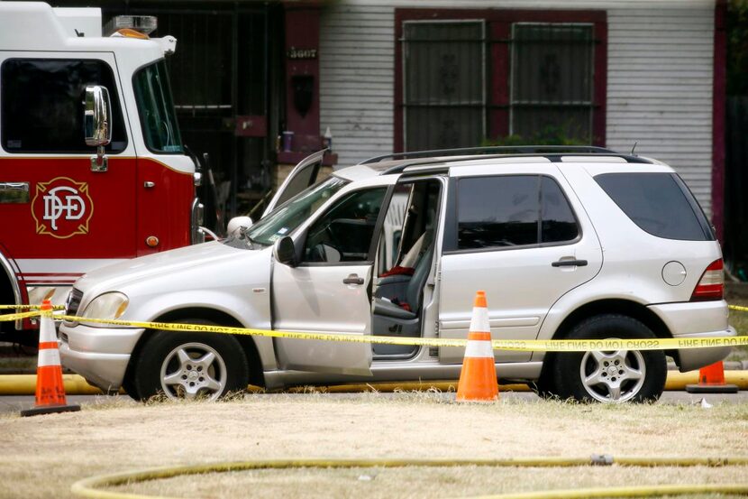 
An SUV that had been driven by Bertrand Syjuan Davis's wife was cordoned off by police tape...