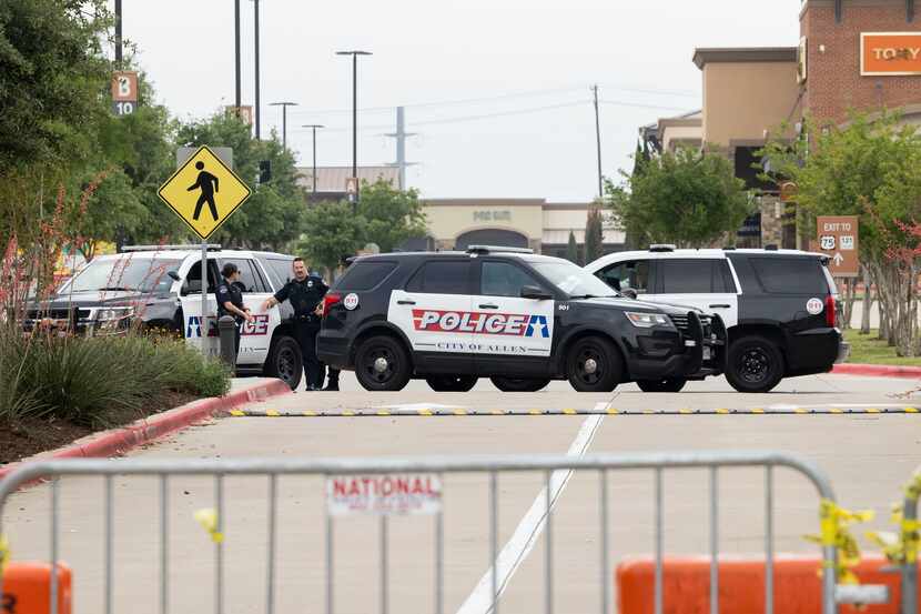 Barricades and police block the entrance to the Allen Premium Outlets mall in Allen on...