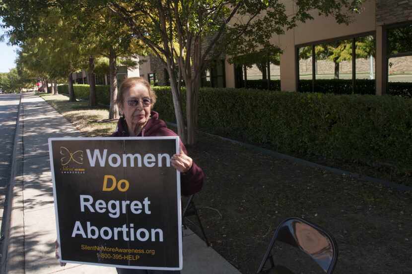 Lupe Del Angel holds a sign outside of the Southwestern Women's Surgery Center in Dallas on...