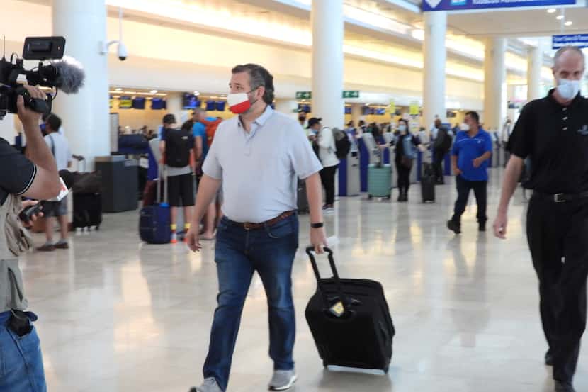 Texas Sen. Ted Cruz checks in for a flight at Cancun International Airport after a backlash...