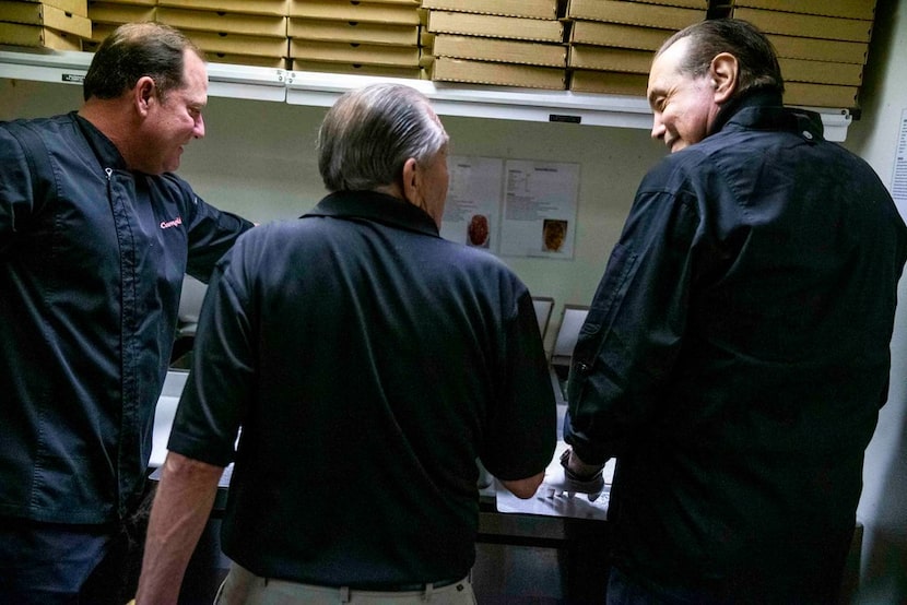 David Campisi (left) and Corky Campisi (middle) show actor Chazz Palminteri how to make...