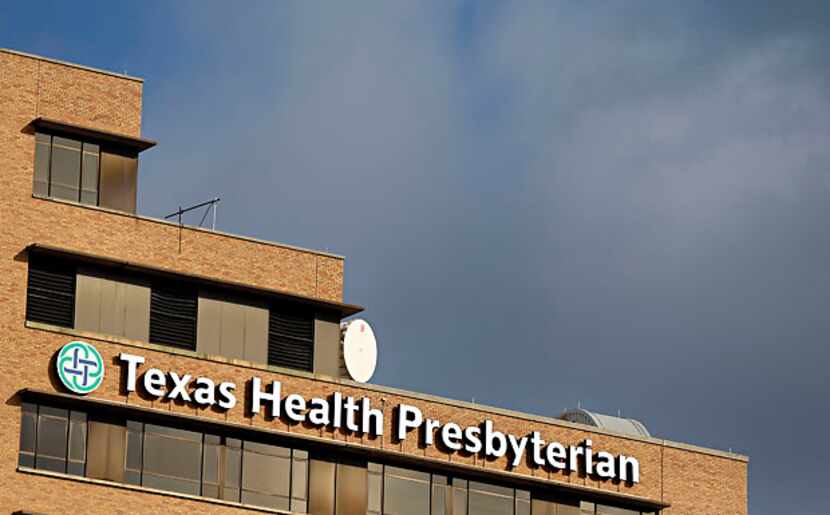A media helicopter buzzes over Texas Health Presbyterian Hospital Wednesday, October 1, 2014...