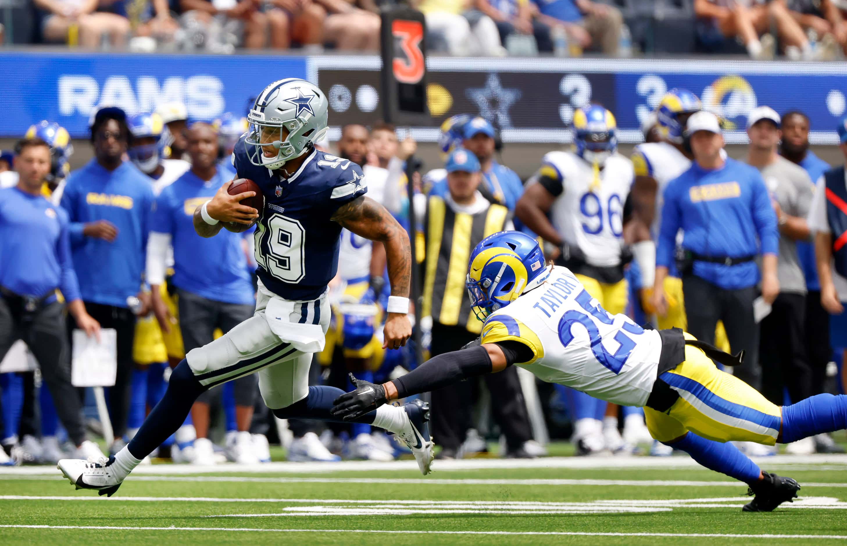 Dallas Cowboys quarterback Trey Lance (19) takes off running as he’s pursued by Los Angeles...