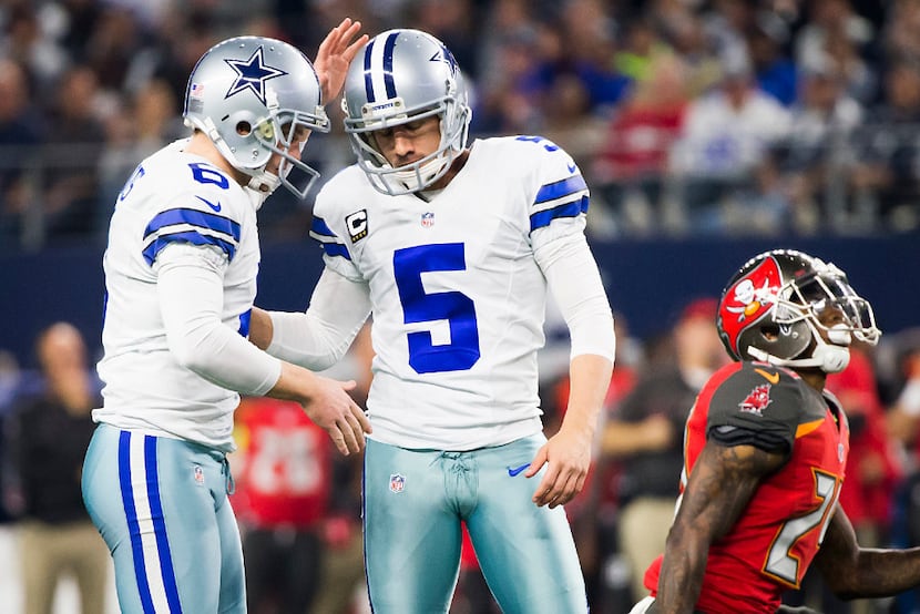 Dallas Cowboys kicker Dan Bailey (5) celebrates with punter Chris Jones (6) after connecting...