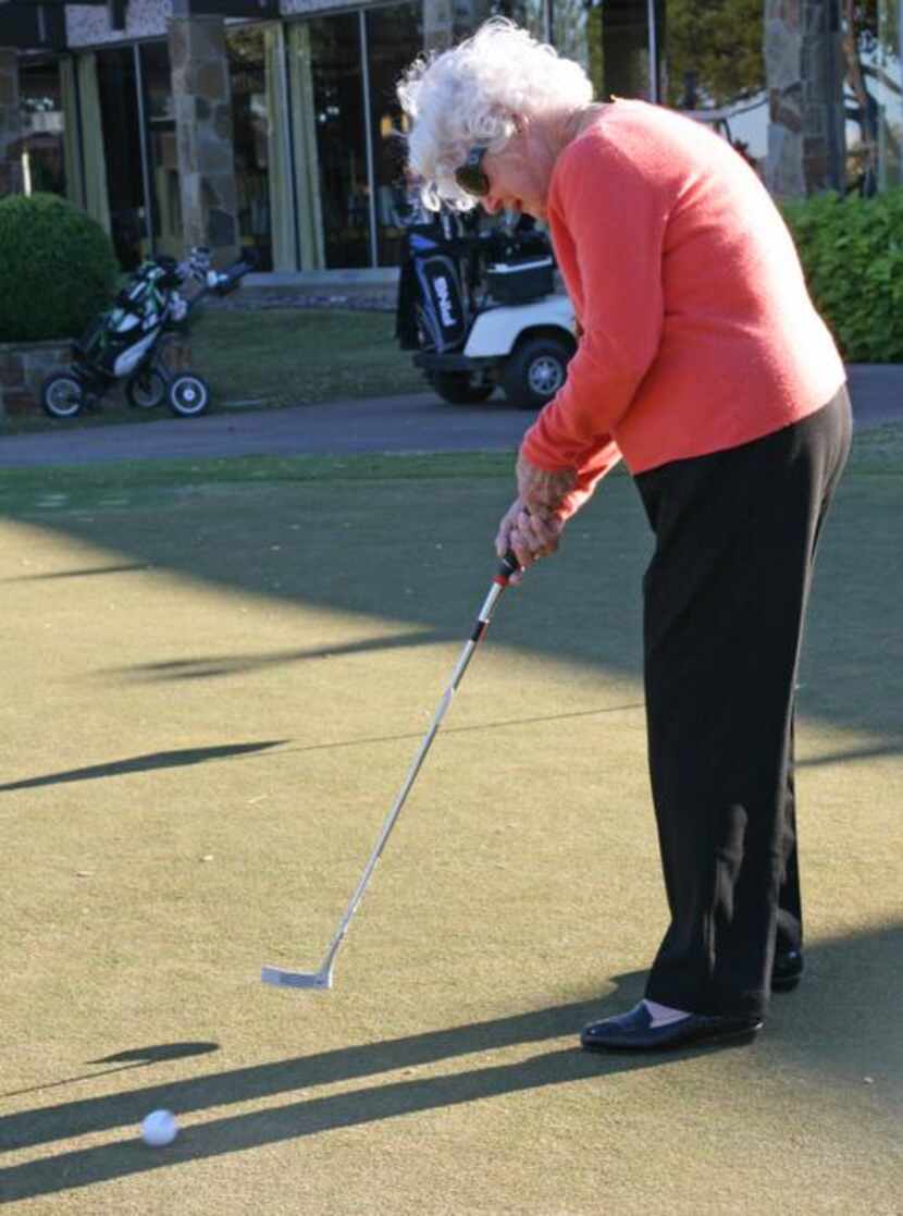 
Wisegarverr practiceson the putting green outside the Brookhaven Country Club pro shop....