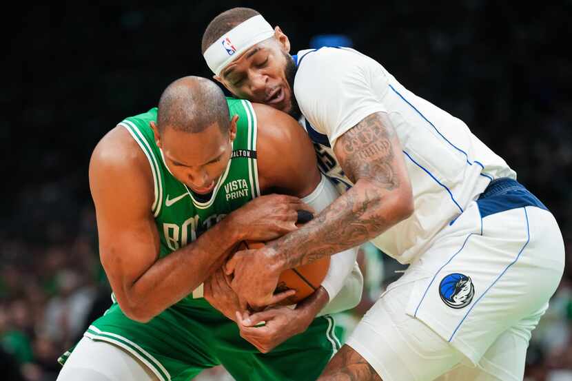 Boston Celtics center Al Horford (42) wrestles for the ball with Dallas Mavericks center...