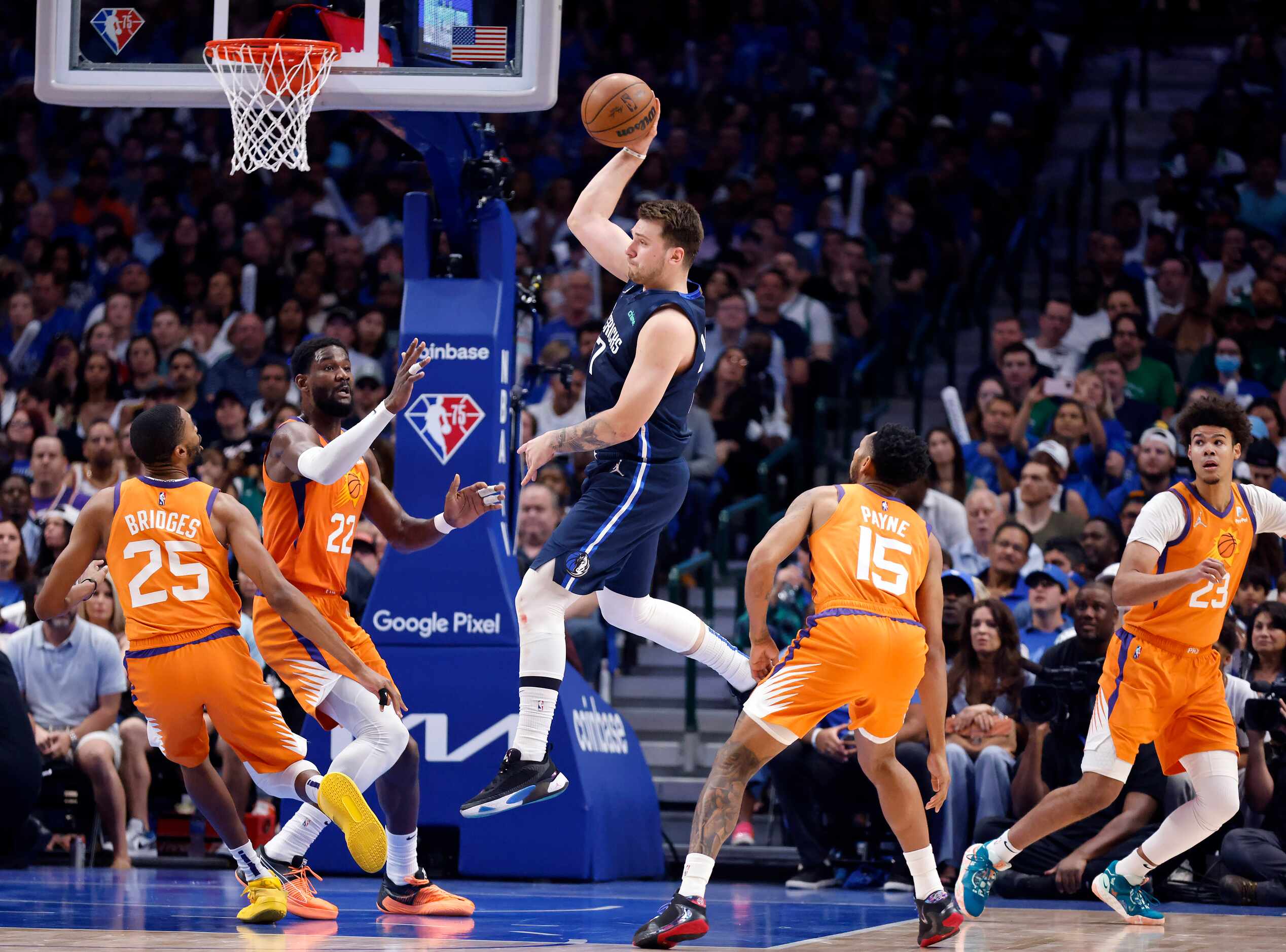 Dallas Mavericks guard Luka Doncic (77) passes the ball as he entered the lane against the...