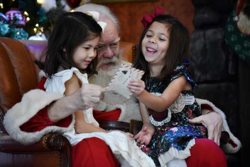 Santa Claus visits with Reece and Reagan Carrasco at NorthPark Center.