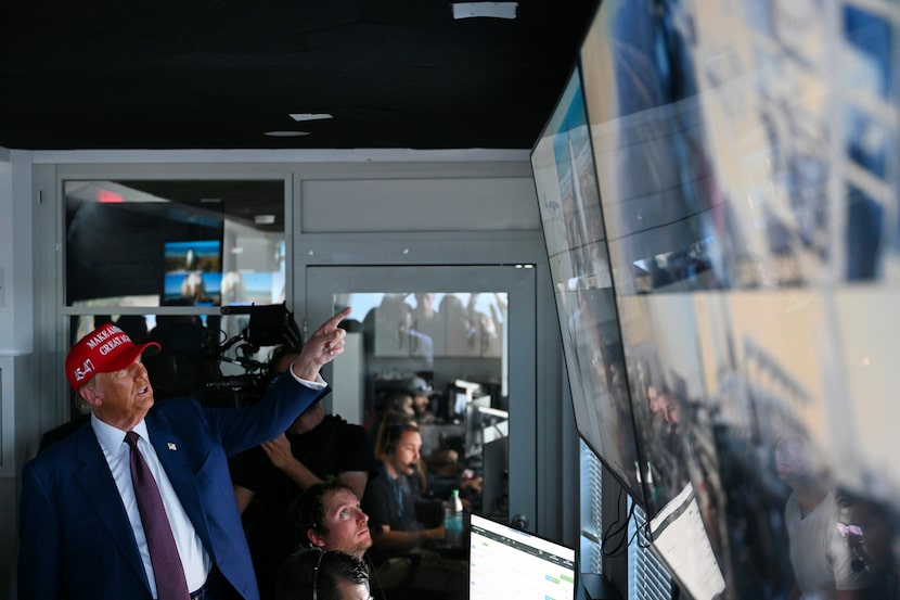 President-elect Donald Trump speaks as Elon Musk explains the operations in the control room...