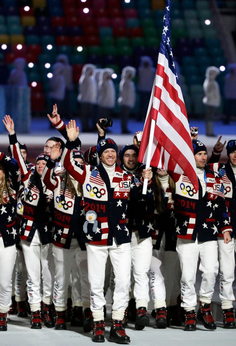 Todd Lodwick of the United States carries the flag as he leads the team during the opening...