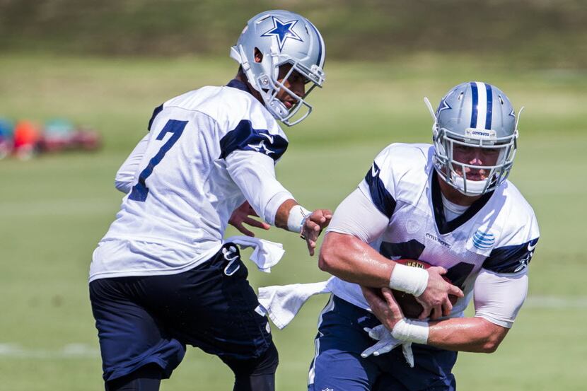 Dallas Cowboys practice squad quarterback Jameill Showers (7) hands off to Dallas Cowboys...