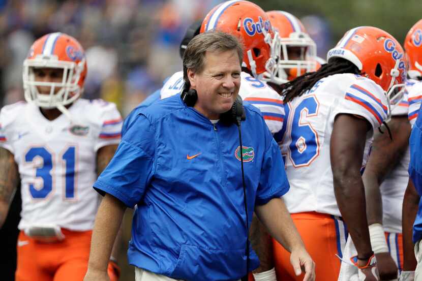 FILE - In this Oct. 1, 2016, file photo, Florida coach Jim McElwain walks the field during a...