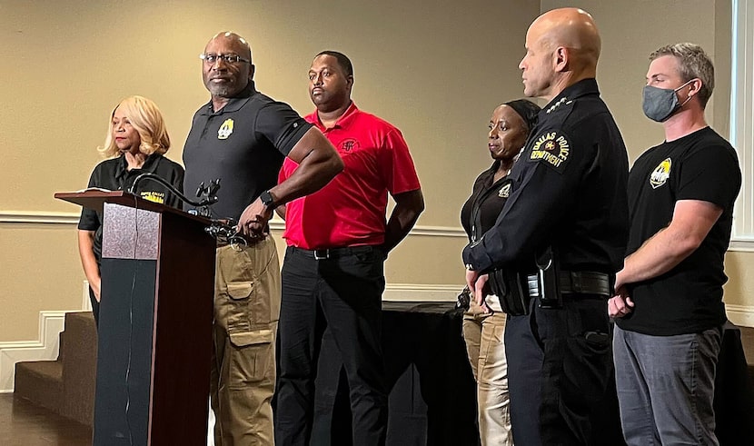 Dallas Police Chief Eddie García (right), listens to Terrance Hopkins (left), President of...