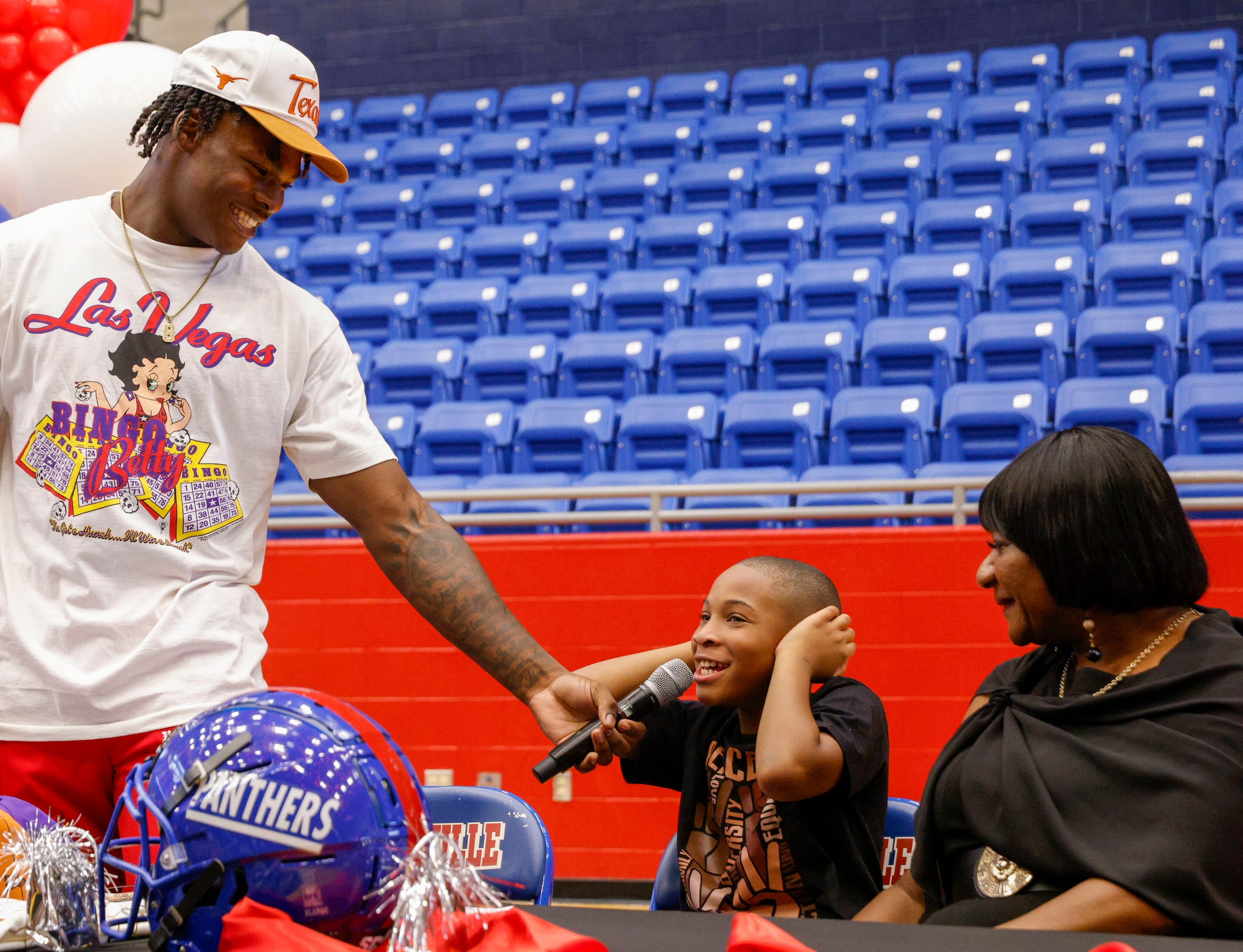 Duncanville defensive lineman Colin Simmons lets his brother Clayton speak alongside his...