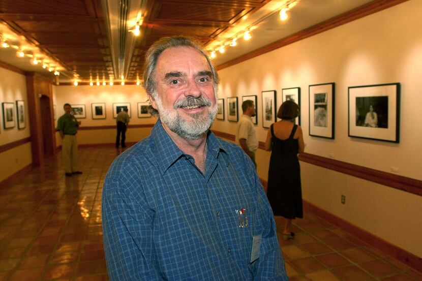 Bill Wittliff stands in a photo exhibit at Texas State University in 2002. 