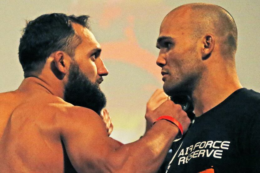 Johny Hendricks poses with opponent Robbie Lawler during UFC weigh-ins at Gilley's in Dallas...
