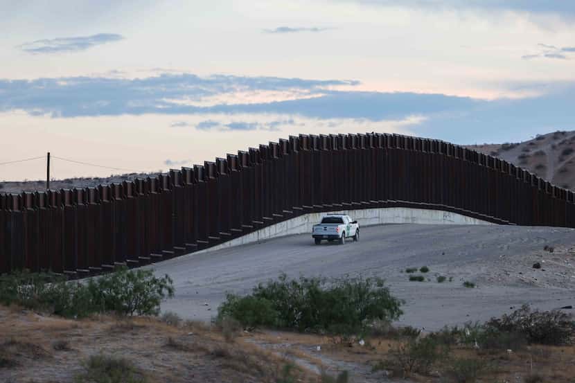 A border patrol drives along a section of the wall at the border with Mexico in Sunland...