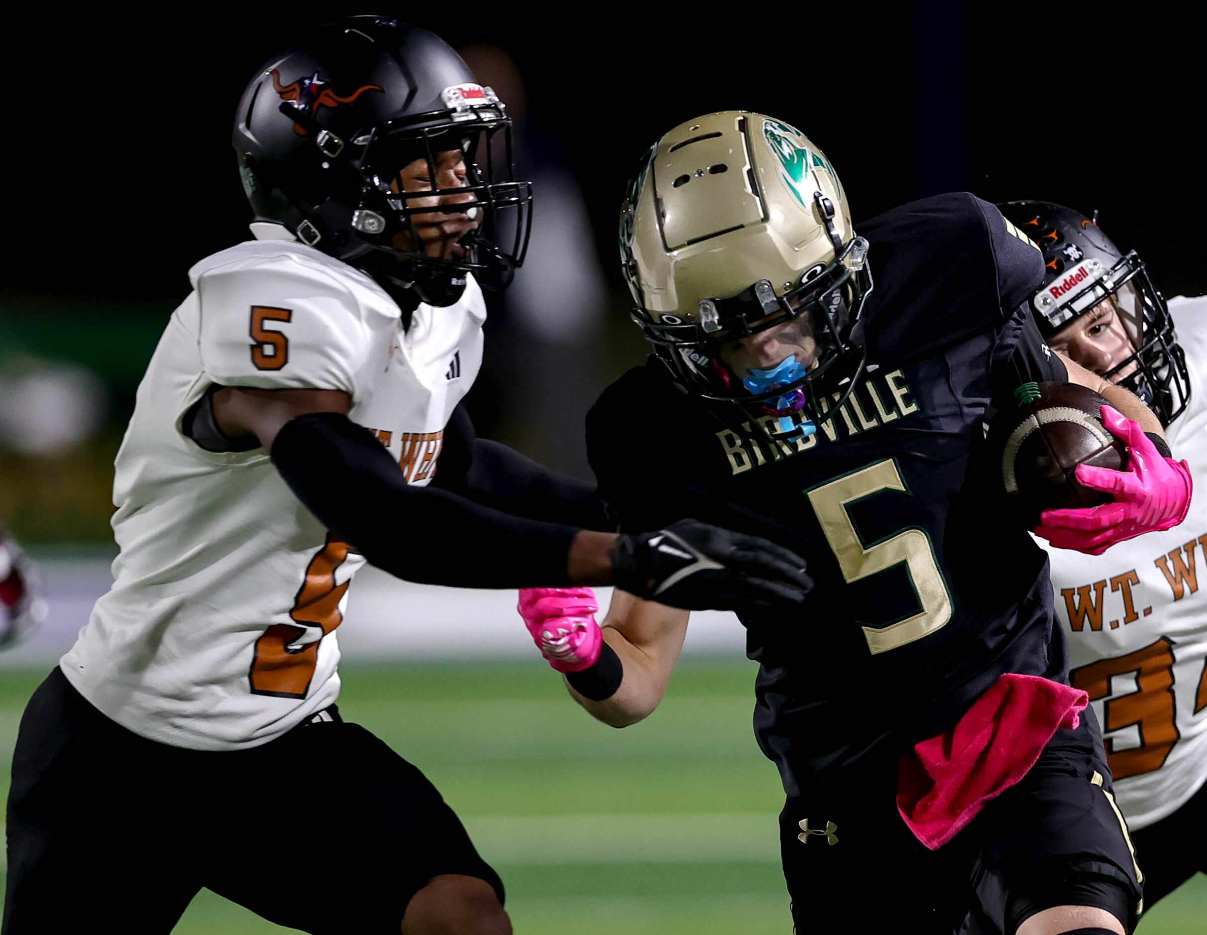 Birdville wide receiver Caleb Kelley (5) makes a reception and is pulled down by W.T. White...
