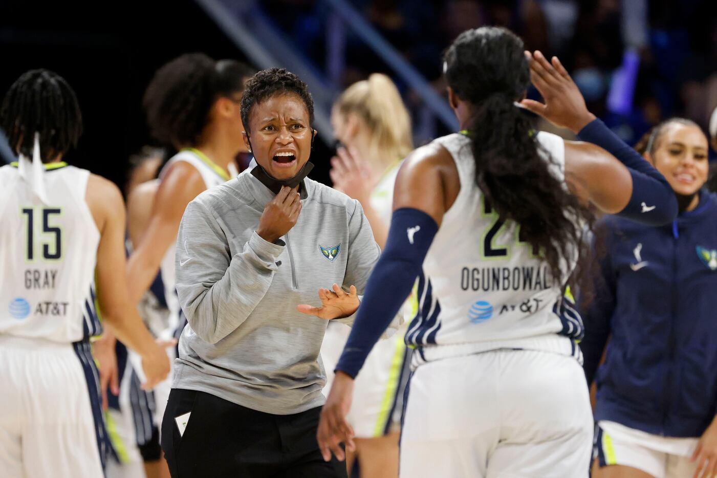Dallas Wings head coach Vickie Johnson celebrates with guard Arike Ogunbowale (24) as they...