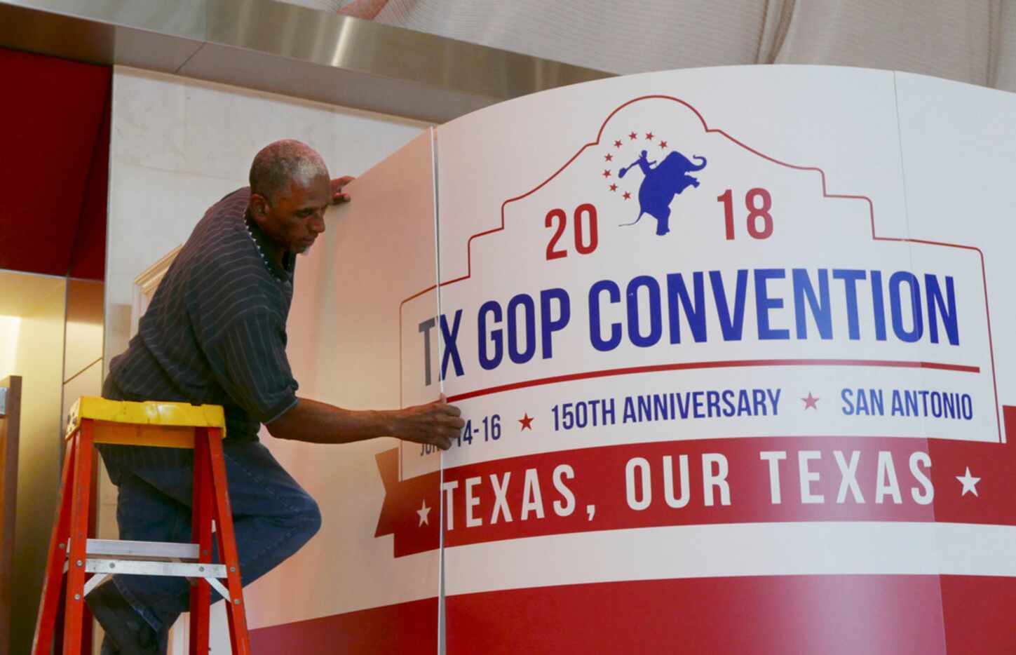 Howard Satterwhite installs a sign at the entrance in preparation for the opening of the GOP...
