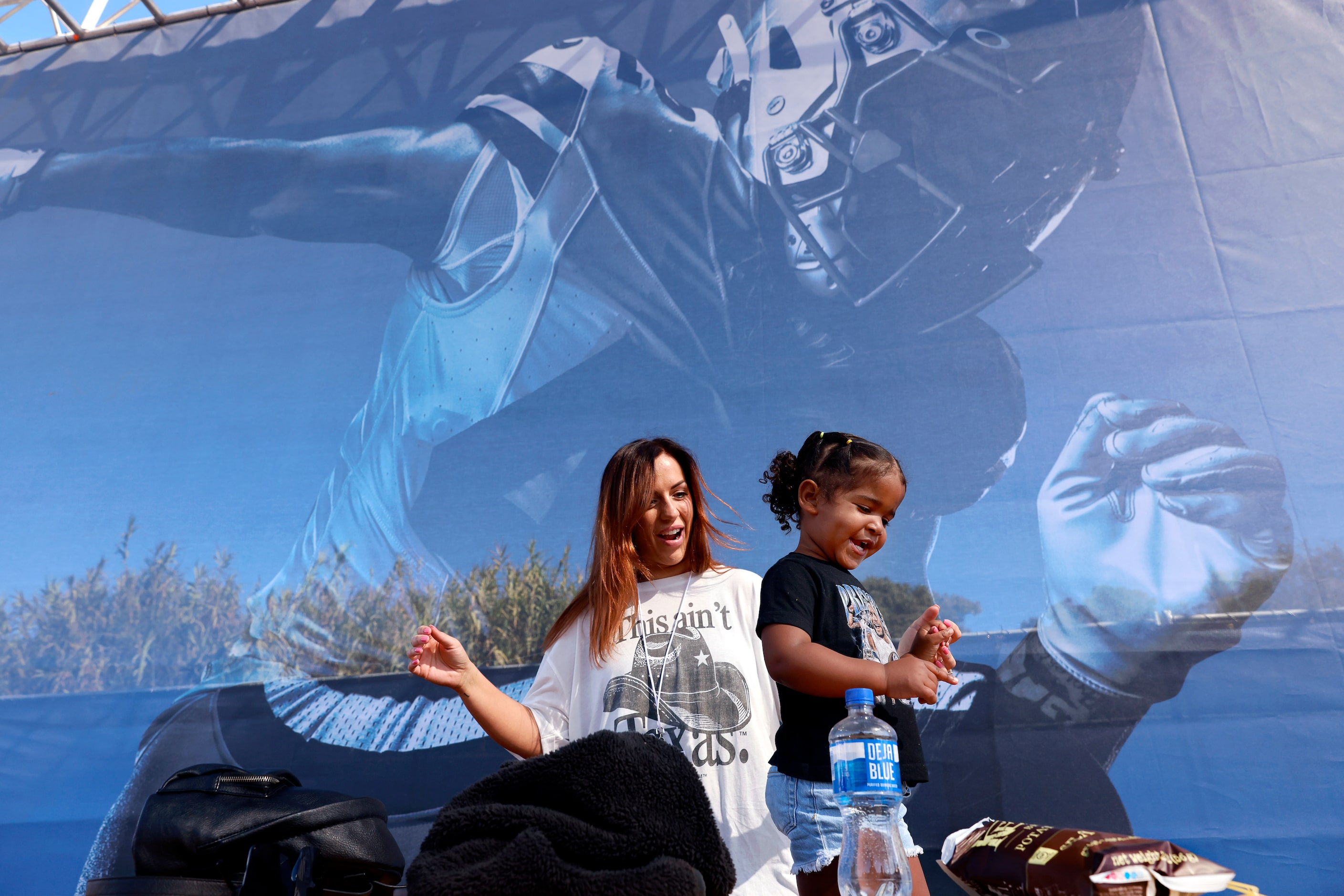 True Williams, 2, dances to the music played by her DJ dad before the annual training camp...