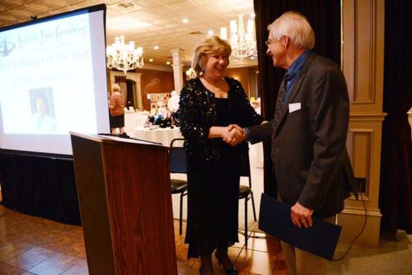 
Sen. Jane Nelson shakes hands with Lewisville Lake Symphony music director Adron Ming at...