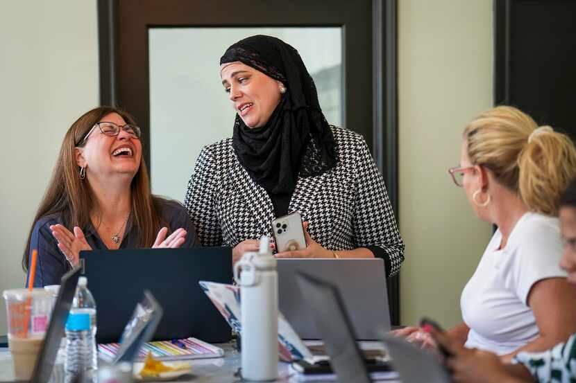 Angela Shipley (left) laughs with fellow Realtors Meaghan Jones (center) and Carrie Solomon...