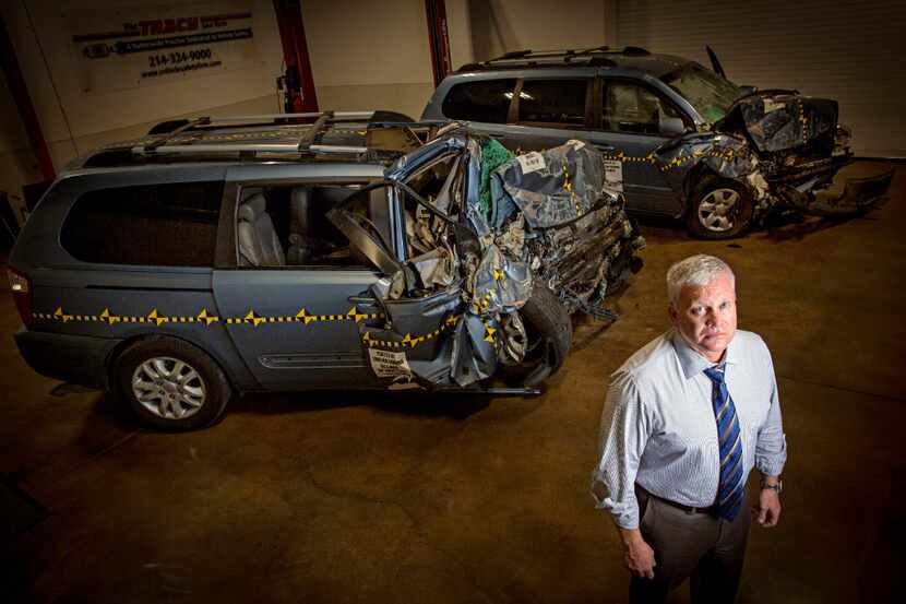 Todd Tracy of Tracy Law Firm stands near crash tested vans at his warehouse in Dallas. (G.J....