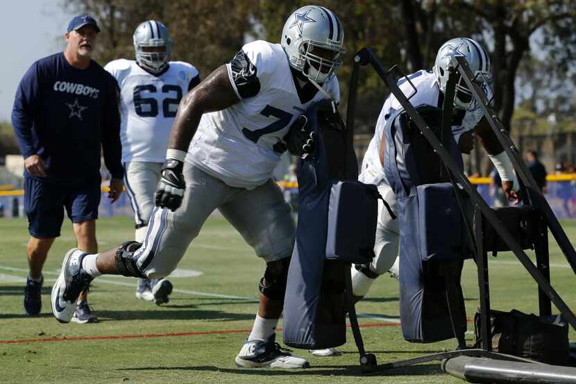 Dallas Cowboys offensive tackle Chaz Green (79) pushes the blocking sled during afternoon...