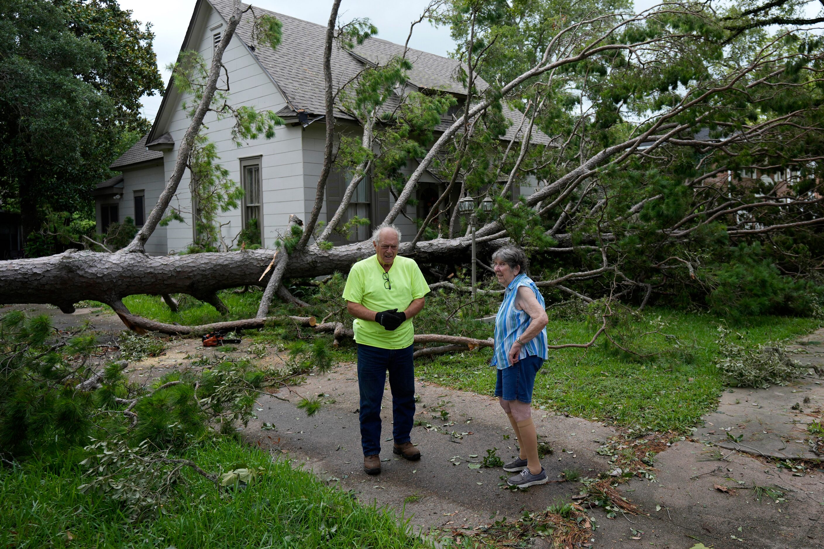 Jackie Jecmenek, right, talks with city worker Bobby Head as she stands in front of her...