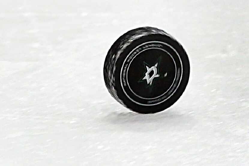 The puck rolls the length of the ice after an officials whistle during the Dallas Stars...