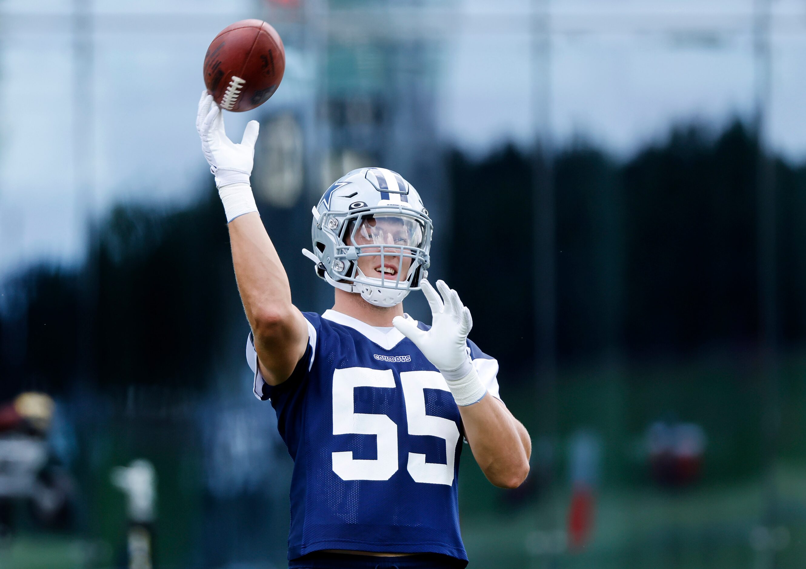 Dallas Cowboys linebacker Leighton Vander Esch (55) tosses the football during practice at...