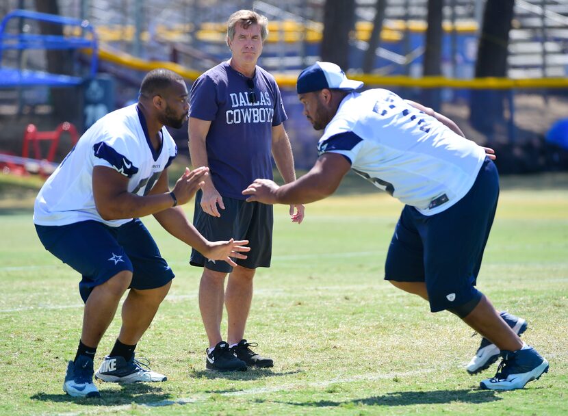 Offensive line coach Bill Callahan watches guards Ronald Leary (65) and Mackenzy Bernadeau...