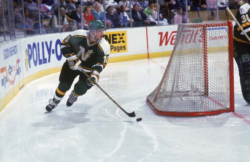 Gaetan Duchesne #10 of the Minnesota North Stars moves the puck from behind the net the...