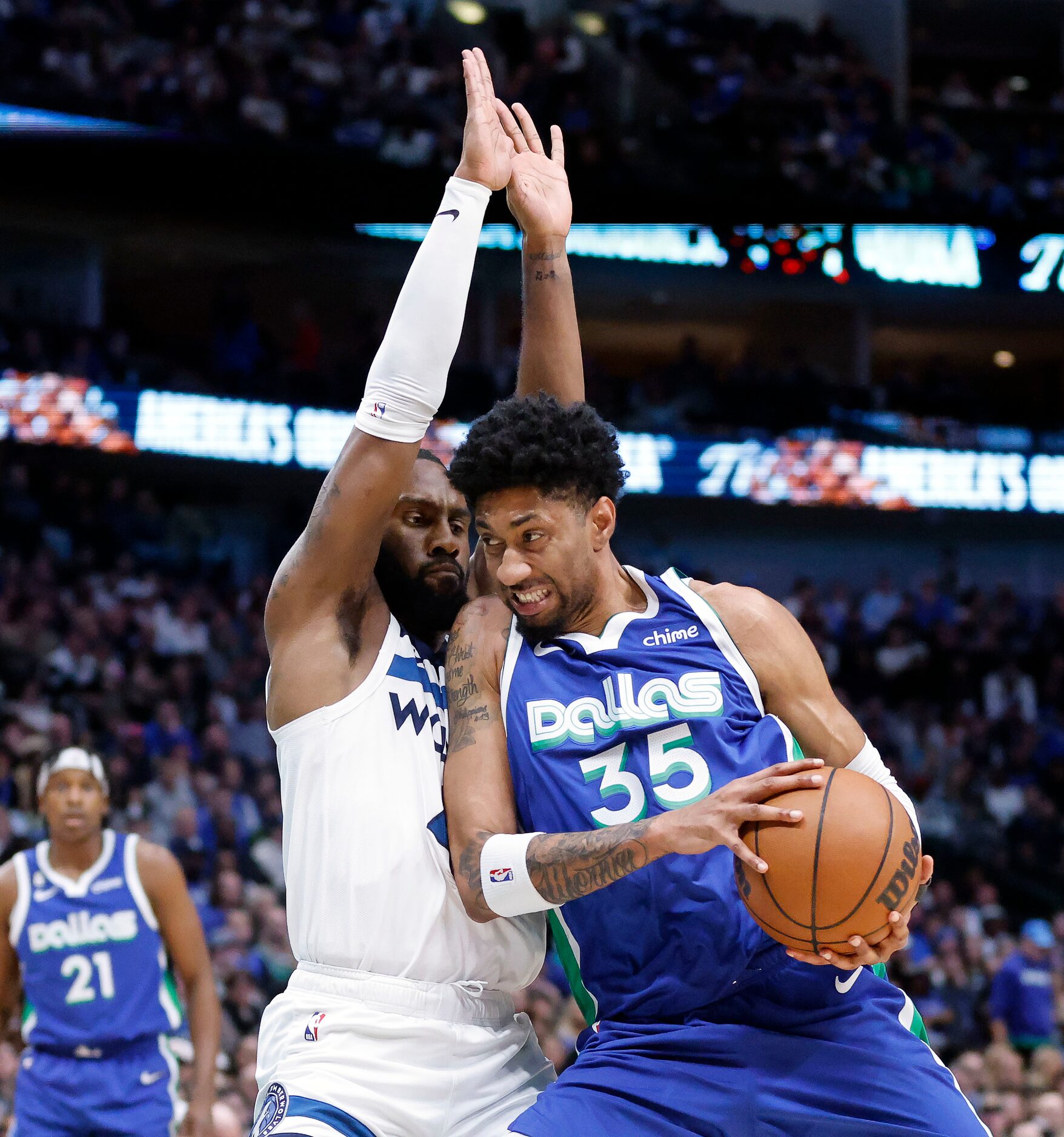 Dallas Mavericks forward Christian Wood (35) leans into Minnesota Timberwolves guard Jaylen...