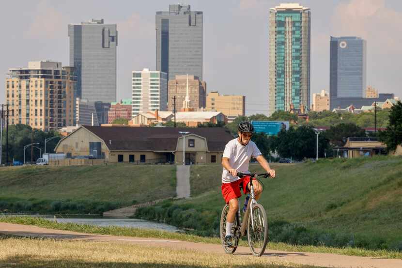 A cyclist rides along the trail at Trinity Park near downtown Fort Worth, Texas, Tuesday,...