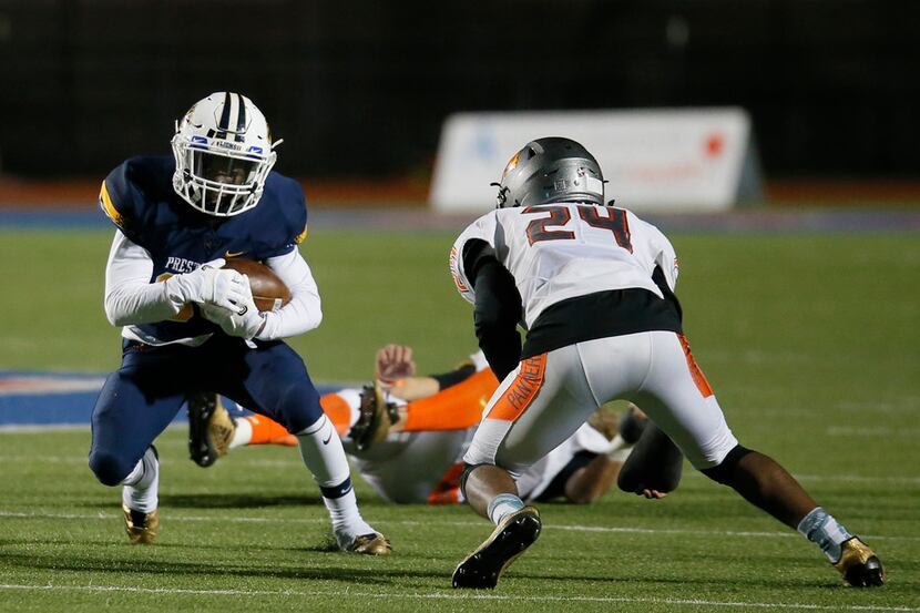 Prestonwood Christian Academy Timothy Taylor (33) is tackled by St. Pius X High School...